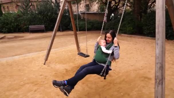 Mamma e bambino in un giro fionda su un'altalena. — Video Stock