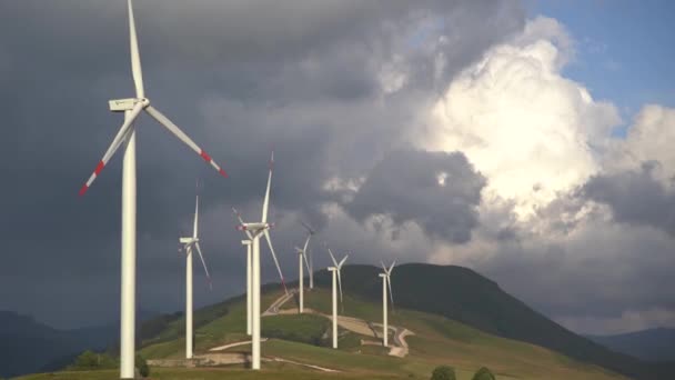 Obrovské větrné turbíny na kopci, na pozadí impozantní oblohy. Větrná elektrárna v severní Černé Hoře. — Stock video