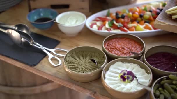 Sauces to appetizers in plates on a buffet table. — Stock Video