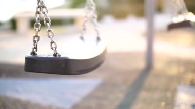 Gün batımında oyun parkında bir zincir salla.