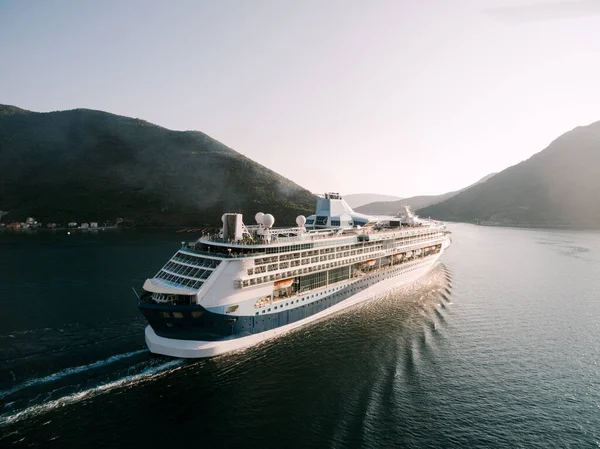 Aerial drone shot - high-rise huge cruise liner in the Verige Strait, in the Boka Kottorska - Kotor Bay in Montenegro, against the backdrop of the city of Perast. — Stock Photo, Image