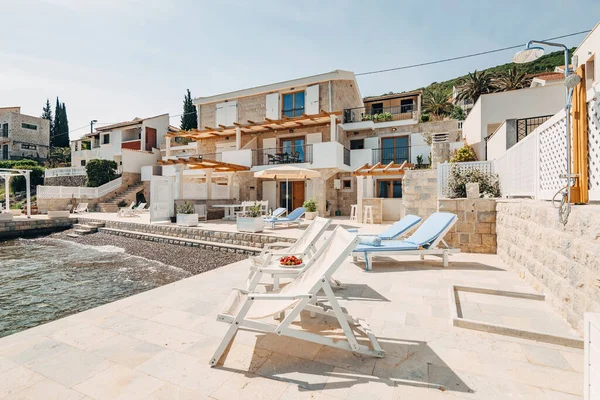 Beach furniture on the stone pier of the villa.