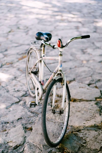Gros plan au premier plan d'une bicyclette sur une route inégale en pierre — Photo