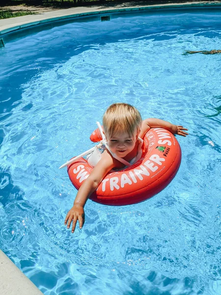 Budva, Montenegro - 01 agosto 2020: Un bambino piccolo nuota in piscina su un anello di nuoto gonfiabile - Nuotatore. — Foto Stock