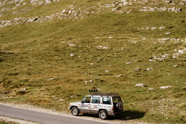 Zabljak, Montenegro - 23 july 2020: Isuzu trooper sports rally off-road car of 1991, in stickers with prizes, parkir di sisi gunung. Stok Foto Bebas Royalti