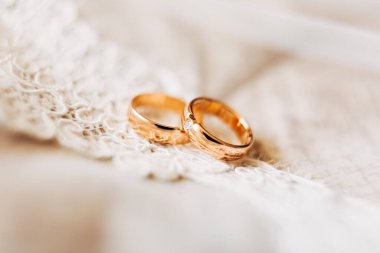 Beyaz dantelli gelin ve damat için iki altın yüzük..