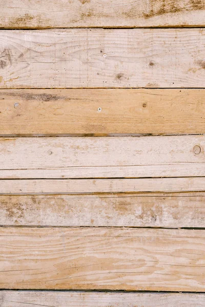 Light-colored fence boards knocked down in a horizontal position. — Stock Photo, Image