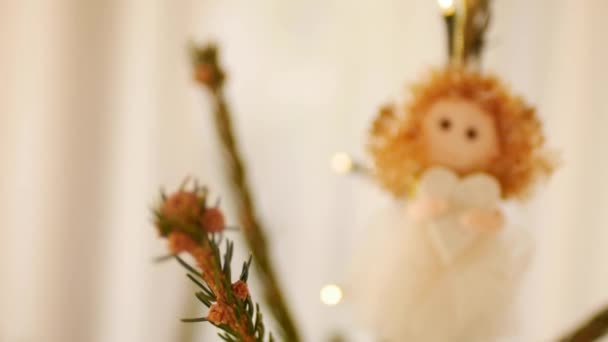 Christmas tree toy on top of a tree - a little girl with a heart in her hands. — Stock Video