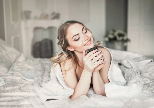 Good morning.Woman wake up in bed. Woman drinking coffee in bed