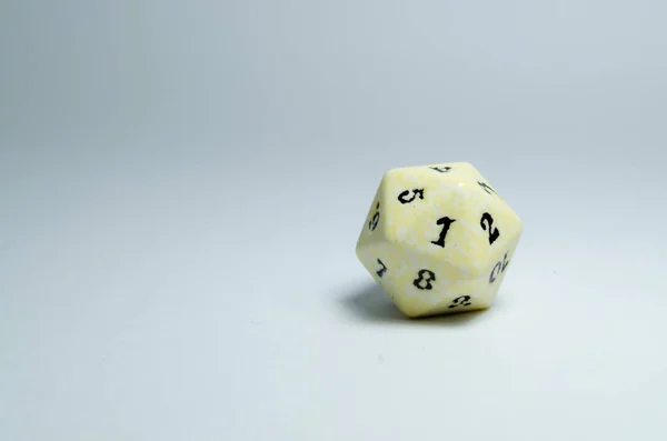 twenty-sided dice, isolated on a white background. Face of number one in focus. dice of role playing game and dungeons and dragons.