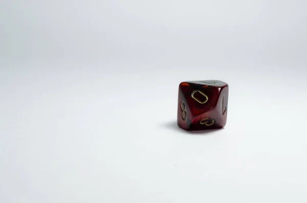 ten-sided dice, red, isolated on a white background with a small shadow. Number zero in focus. Dice of role playing game and dungeons and dragons.