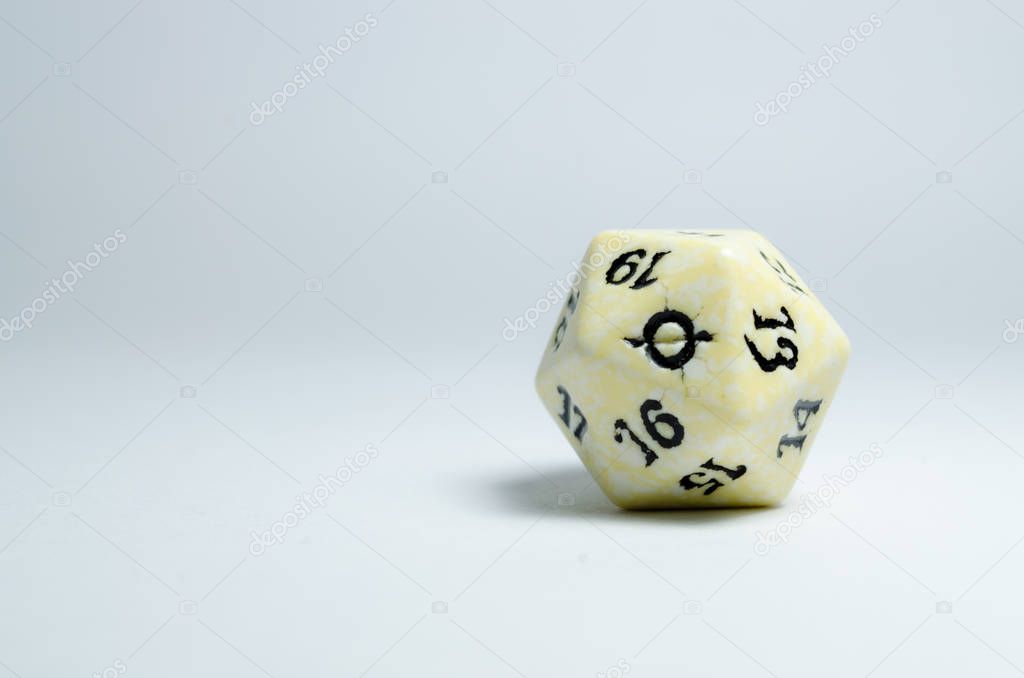 twenty-sided dice, isolated on a white background. Face of number twenty in focus. dice of role playing game and dungeons and dragons.