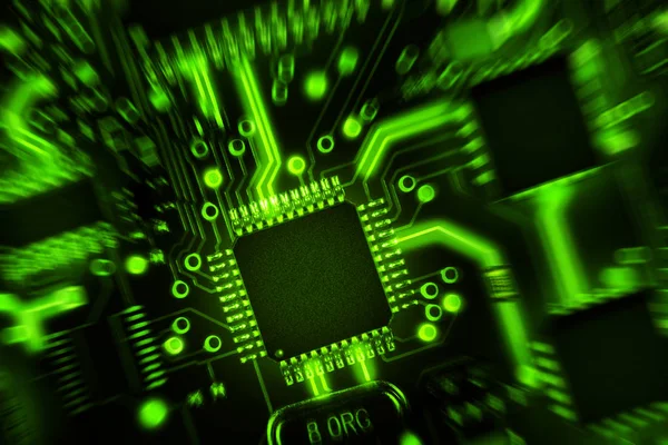 Circuit board with components in green tones. Abstract high tech background. Zoom effect.