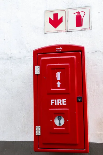 A Close up view of a red fire extinguishes box incase of a fire