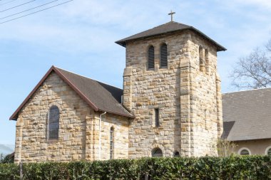 Taş bir kilise ile yeşil bitki çitlerinde kilisenin etrafında ana çit üzerinden üst bir yan görünüm 