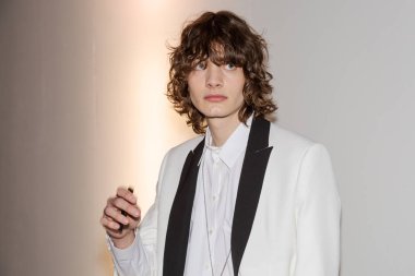 MILAN, ITALY - JANUARY 14: Beautiful model poses in the backstage just before Isabel Benenato show during Milan Men's Fashion Week on JANUARY 14, 2019 in Milan.