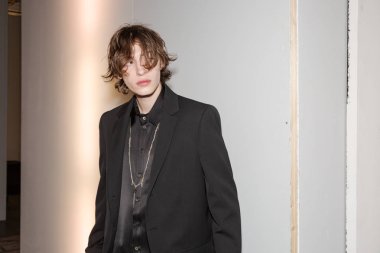 MILAN, ITALY - JANUARY 14: Beautiful model poses in the backstage just before Isabel Benenato show during Milan Men's Fashion Week on JANUARY 14, 2019 in Milan.