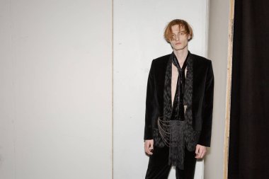MILAN, ITALY - JANUARY 14: Beautiful model poses in the backstage just before Isabel Benenato show during Milan Men's Fashion Week on JANUARY 14, 2019 in Milan.
