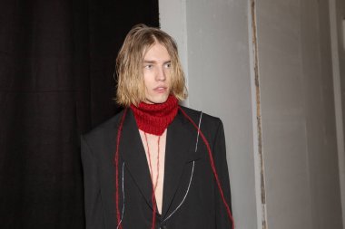 MILAN, ITALY - JANUARY 14: Beautiful model poses in the backstage just before Isabel Benenato show during Milan Men's Fashion Week on JANUARY 14, 2019 in Milan.