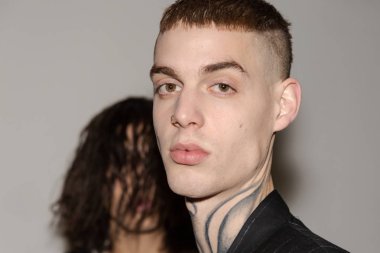 MILAN, ITALY - JANUARY 14: Beautiful model poses in the backstage just before Isabel Benenato show during Milan Men's Fashion Week on JANUARY 14, 2019 in Milan.