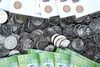 still-life from russian coins and a bundle of russian banknotes close up clipart