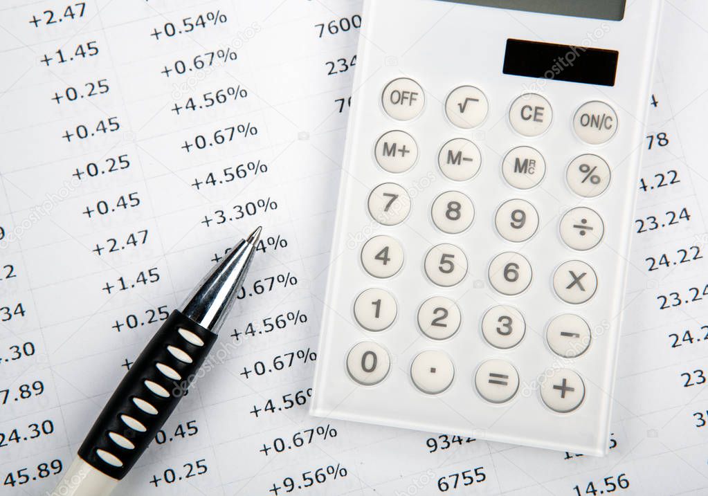 calculator with numbers and pen on the desktop top view