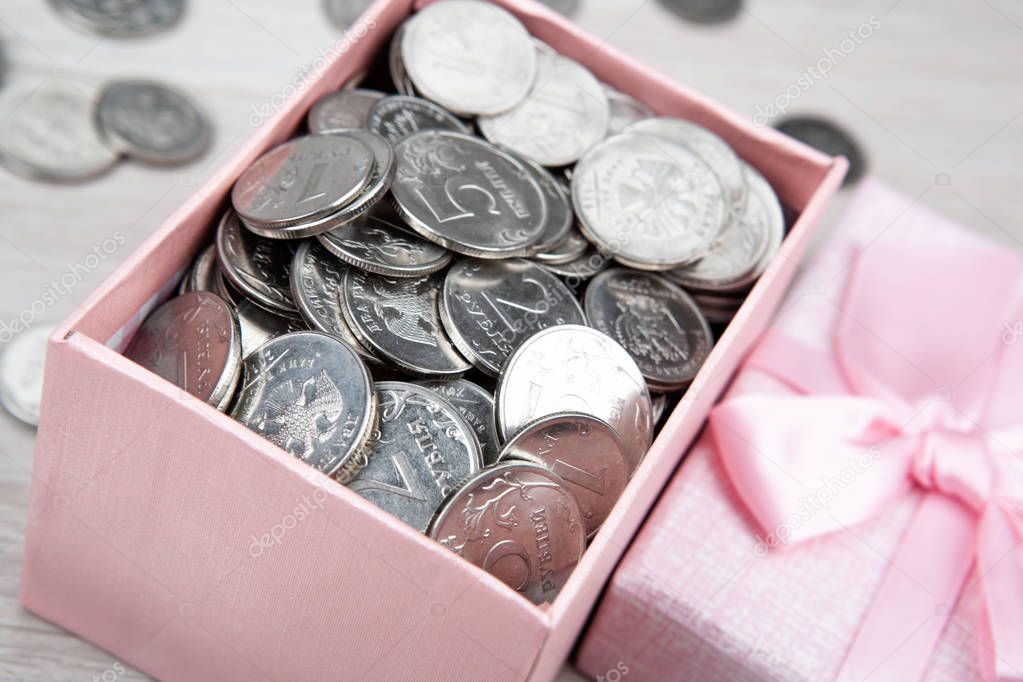 open pink gift box with russian ruble coins close up