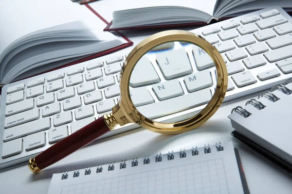 Magnifying glass on the pc keyboard search technology concept — Stock Photo, Image