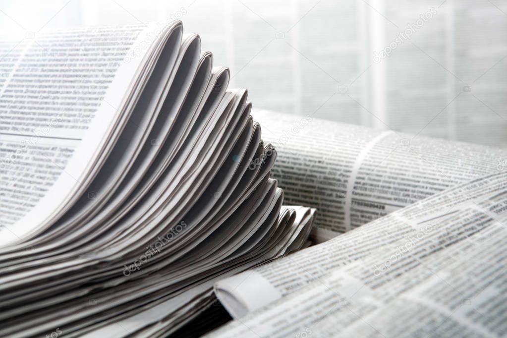 piles of numerous printed newspapers