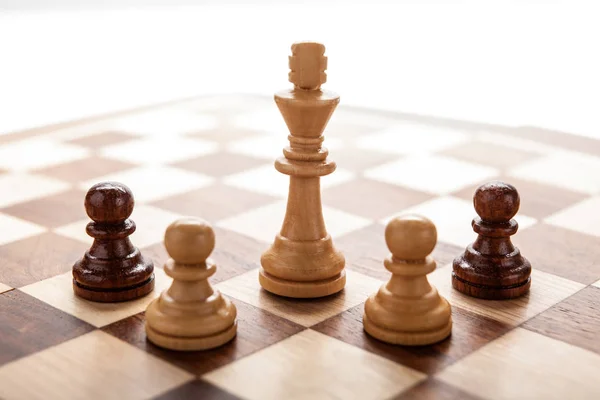 Bois blanc roi des échecs entre pions d'échecs — Photo