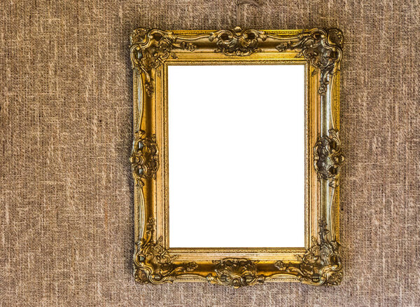Empty expensive looking antique golden painting frame work hanging on a jute cloth wall background