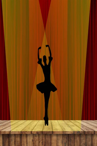 Ballerina silhouette of young dancing elegant ballet girl on pointe shoes on stage in the spotlights with a red curtain background