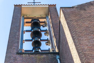 group of church bells hanging in a church tower for ringing clipart