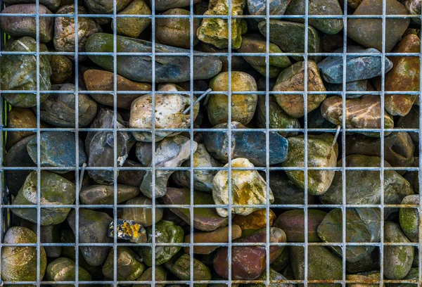 Metal basket full of pebble stones, decorative garden architecture background — Stock Image Metal basket full of pebble stones, decorative garden architecture background Stock Image