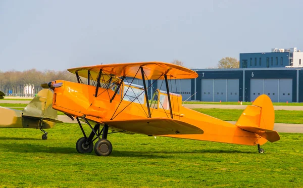 Parked orange stunt airplane at the airport, acrobatic flying and extreme hobbies — Stock Photo, Image