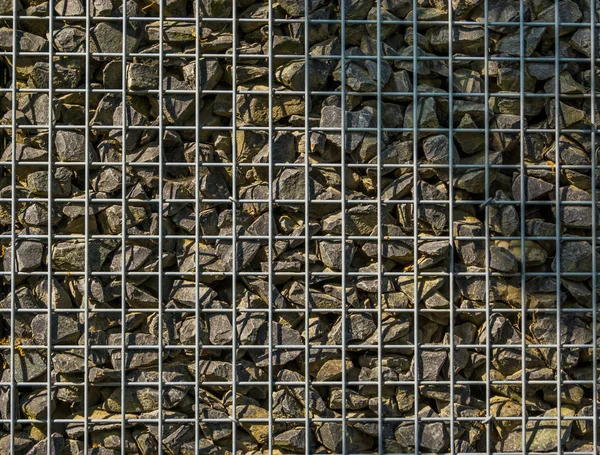 Filled mesh basket with small rocks, garden architecture background, pattern of pebbles — Stock Image Filled mesh basket with small rocks, garden architecture background, pattern of pebbles Stock Photo
