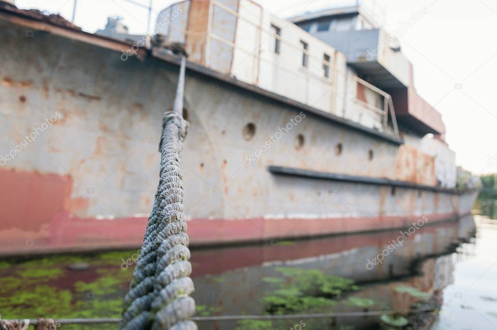 Old steel cable on the background of defocused ship