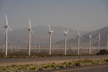Green energy wind turbines fields on the hills near Palm Springs in California clipart