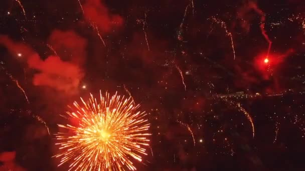 Fényes tűzijáték robbanás az éjszakai égbolton. A tűzijáték tiszteleg a fekete égbolt hátterével. Újévi tűzijáték. A Függetlenség Napját ünnepeljük. Színes tűzijáték..