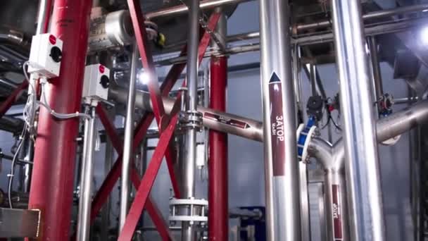 Production of beer steel reservoirs and pipes in a brewery. Beer manufacture line equipment for staged production bottling of finished food products metal piper. Modern brewery. — Stock Footage Production Beer Steel Reservoirs Pipes Brewery Beer Manufacture Line Equipment Royalty Free Stock Footage