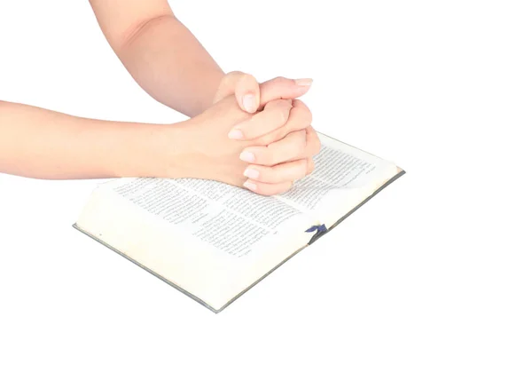 Unrecognizable woman with Bible praying on white background