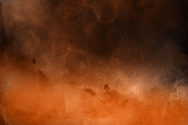 Orange watercolor paint on paper abstract background