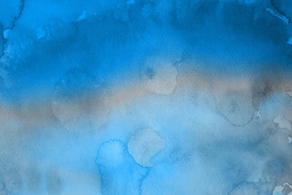 blue watercolor paint on paper abstract background