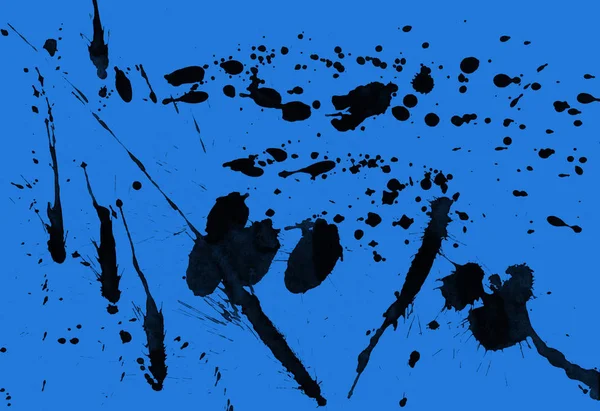 abstract black paint splatters texture on blue background