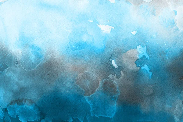 blue watercolor paint on paper abstract background