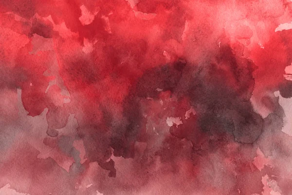 red watercolor paint on paper abstract background