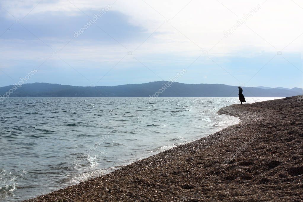 Woman silhouette on the Adriatic Sea coast.