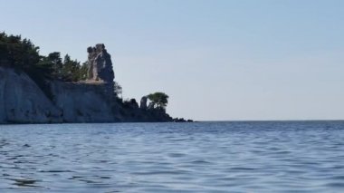Adada Gotland, İsveç'in Lickershamn köyü yanında. Ön plan ve arka planda sahil denizde. Kayalıklarla ve kayalar Gotland Adası'nın tipik peyzaj formu.