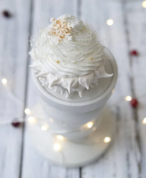 Pavlova cake with strawberries and chocolate icing. New Years concept. Celebratory concept. Christmas cake. Close up, selective focus