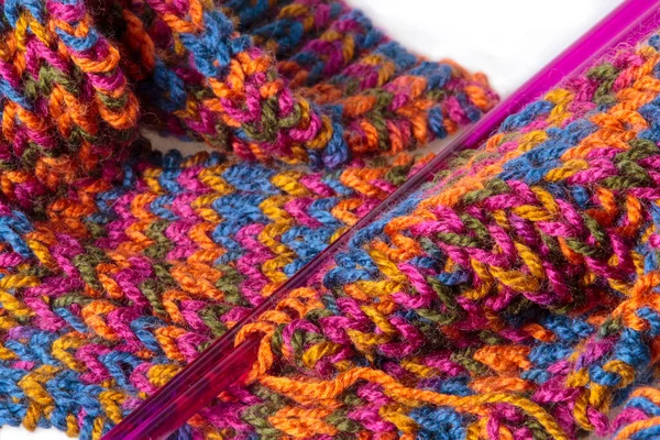 Unfinished handmade woolen scarf and knitting needles — Stock Photo, Image